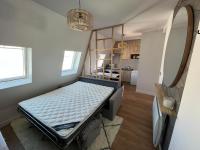 a bedroom with a bed in the corner of a room at Rooms with fabulous view on Paris roofs in Paris