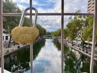 a heart shaped padlock in front of a river at Rooms with fabulous view on Paris roofs in Paris