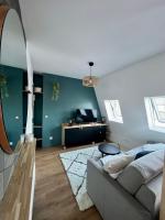 a living room with a couch and a mirror at Rooms with fabulous view on Paris roofs in Paris