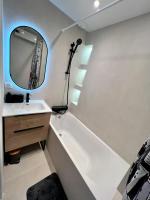 a bathroom with a sink and a tub and a mirror at Rooms with fabulous view on Paris roofs in Paris