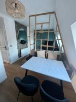 a dining room with a table and chairs at Rooms with fabulous view on Paris roofs in Paris