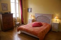 a bedroom with a bed and two tables and a window at Chambres d&#39;Hôtes Villa Bellevue in Albi