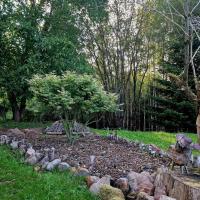 a garden with a pile of rocks and a tree at La Maison Thébaïde in Mortagne