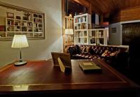 a living room with a couch and a table with a lamp at La Maison Thébaïde in Mortagne