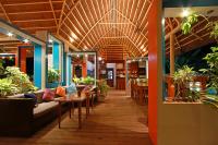 a restaurant with tables and chairs and plants at Villa Kasadya in Panglao