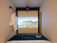 a bedroom with a sliding glass door with a mountain view at The Millennials Kyoto in Kyoto