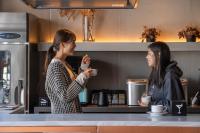 two women standing in a kitchen talking at The Millennials Kyoto in Kyoto