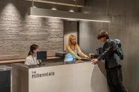 a man and woman standing at a counter in an office at The Millennials Kyoto in Kyoto