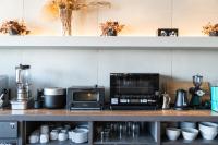 a kitchen with a counter with a microwave and appliances at The Millennials Kyoto in Kyoto
