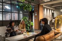 a group of women sitting around a table in a room at The Millennials Kyoto in Kyoto
