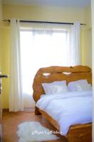 Mupa's Luxury Condo IIにあるベッド