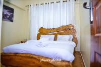 Mupa's Luxury Condo IIにあるベッド
