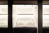 a room with two windows and a couch at The Millennials Kyoto in Kyoto