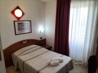 A bed or beds in a room at Hotel Della Volta
