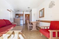 a living room with a red couch and a table at Appartement 4p - Parking Privé in Les Deux Alpes