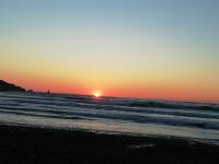 a sunset on a beach with the ocean at château de Locquéran Pierres et filets bleus in Plouhinec