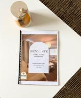 a picture of a book with a bottle of perfume at Chambre PHARE en Coliving in Brest