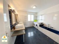 a bathroom with a sink and a washing machine at Chambre PHARE en Coliving in Brest