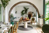 a dining room with a table with food on it at César Lanzarote Luxury Boutique Hotel - Adults Only in La Asomada