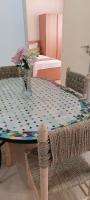 a dining room table with a patterned table cloth at Essaouira Cool apartments in Essaouira