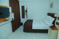 Utsavam Hotel Apartmentsにあるベッド