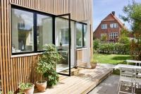 a glass extension to a house with a patio at House in beautiful Copenhagen in Copenhagen