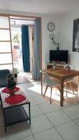 a living room with a table and a chair at Le Mooréa 2 est à 5 min de l&#39;hyper centre et plages in Sausset-les-Pins