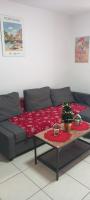 a living room with a couch with a table at Le Mooréa 2 est à 5 min de l&#39;hyper centre et plages in Sausset-les-Pins