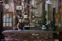 a woman standing behind a bar in a restaurant at Wave-F in Ko Kood