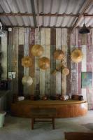 a room with umbrellas hanging on a wall at Wave-F in Ko Kood