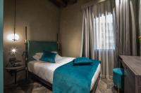 A bed or beds in a room at Hotel Forte del 48