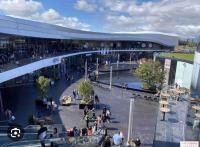 a group of people walking around a shopping mall at Appartement gare Plaisir grignon in Plaisir