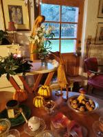 a table with pumpkins and a bird on top of it at Les Hotes Des Guillemets in Laglorieuse