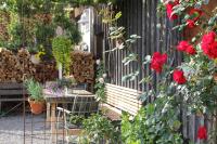 a garden with a bench and red roses at Bio Ferienbauernhof Greber in Schwarzenberg