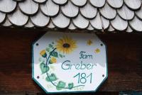 a sign on the side of a roof with a sunflower at Bio Ferienbauernhof Greber in Schwarzenberg