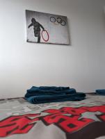 a bedroom with a bed with a picture on the wall at Appartement 6-8 personnes - Calme - Neuf - 15 min de Paris in Groslay