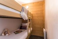 a bedroom with two bunk beds and a teddy bear at Résidence Pierre &amp; Vacances Les Néréides in Belle Plagne