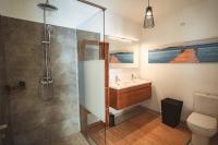 a bathroom with a shower and a sink at KozyKaz, notre villa cocooning avec piscine in Saint-Pierre