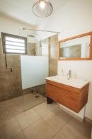 a bathroom with a sink and a shower at KozyKaz, notre villa cocooning avec piscine in Saint-Pierre