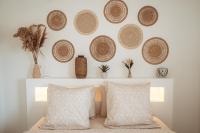 a bedroom with a wall with baskets and pillows at KozyKaz, notre villa cocooning avec piscine in Saint-Pierre