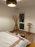 a bedroom with a bed and a window and a lamp at Superbe Appartement atypique in Bouleternère