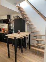 a kitchen with a wooden table and a staircase at Superbe Appartement atypique in Bouleternère