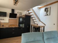 a living room with a blue couch and a staircase at Superbe Appartement atypique in Bouleternère