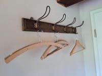 a wooden rack with two hangers on a wall at Pension Müllers Mühle in Großenhain