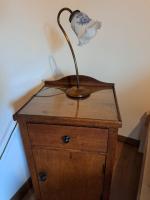 a lamp sitting on top of a wooden dresser at Pension Müllers Mühle in Großenhain