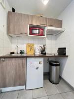 a kitchen with a white refrigerator and a microwave at Mon Cocon Occitan - 2p - Wifi &amp; Parking in Colomiers