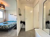 a bedroom with a bed and a mirror at Mon Cocon Occitan - 2p - Wifi &amp; Parking in Colomiers