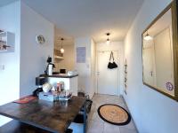 a kitchen with a wooden table in a room at Mon Cocon Occitan - 2p - Wifi &amp; Parking in Colomiers