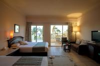 A bed or beds in a room at Hurghada Coral Beach Hotel