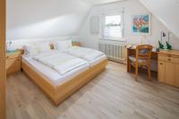 Postel nebo postele na pokoji v ubytování Ferienwohnung Dünenrose